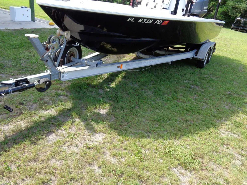 Slide: The Image of 2011 Cape Horn 23 Cape Bay boat on a trailer, parked on grass. - 31