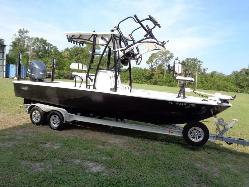 Slide: The Image of 2011 Cape Horn 23 Cape Bay boat on a trailer in a grassy area. - 6