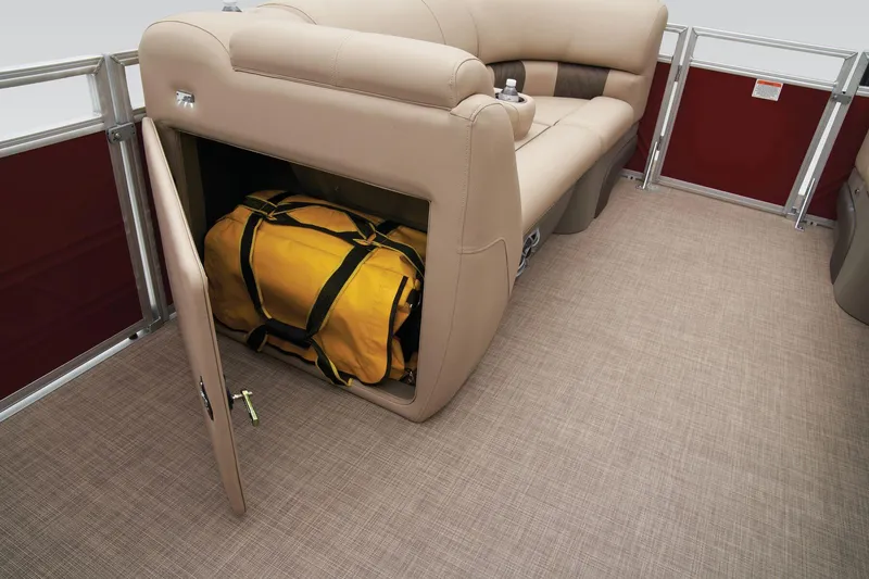 Slide: The Image of 2024 Sun Tracker Party Barge 20 DLX storage compartment with yellow duffel bag. - 27