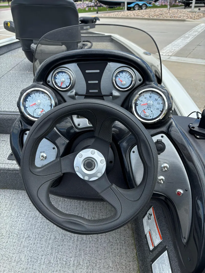 Slide: The Image of 2024 Tracker Pro Team 175 TXW boat dashboard with steering wheel and gauges. - 6