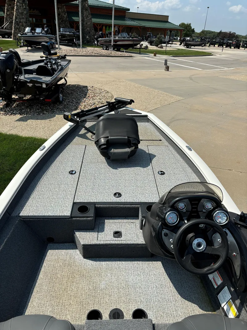 Slide: The Image of 2024 Tracker Pro Team 175 TXW fishing boat interior with steering console and seating. - 7