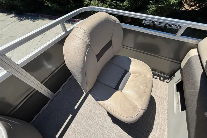 Slide: The Image of 2024 Sun Tracker Fishin' Barge 20 DLX boat seat, beige upholstery, outdoor setting. - 44