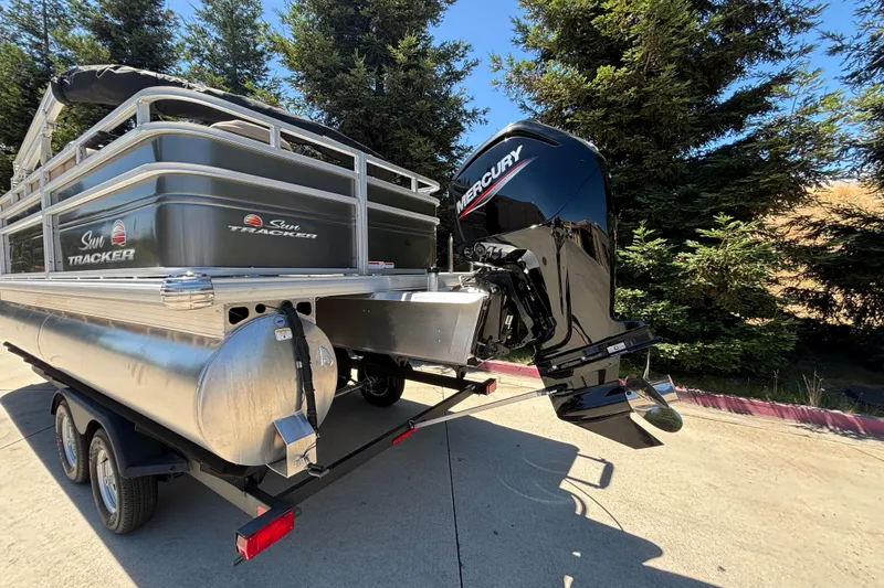 Slide: The Image of 2024 Sun Tracker Fishin' Barge 20 DLX pontoon boat with Mercury outboard motor. - 5