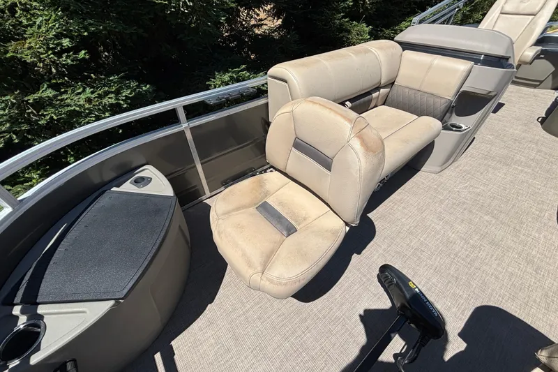 Slide: The Image of 2024 Sun Tracker Fishin' Barge 20 DLX interior with beige seating and fishing amenities. - 19