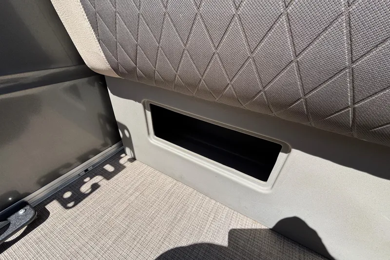 Slide: The Image of 2024 Sun Tracker Fishin' Barge 20 DLX seat storage compartment detail. - 47