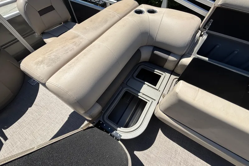 Slide: The Image of 2024 Sun Tracker Fishin' Barge 20 DLX interior seating with storage compartments. - 42