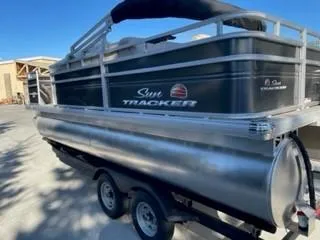 Slide: The Image of 2024 Sun Tracker Fishin' Barge 20 DLX pontoon boat on trailer. - 5