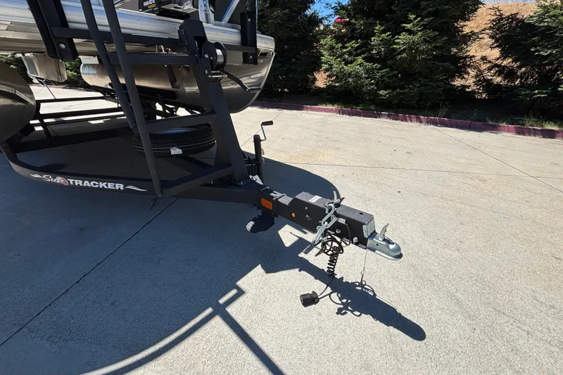 Slide: The Image of 2024 Sun Tracker Fishin' Barge 20 DLX trailer hitch on concrete surface. - 31