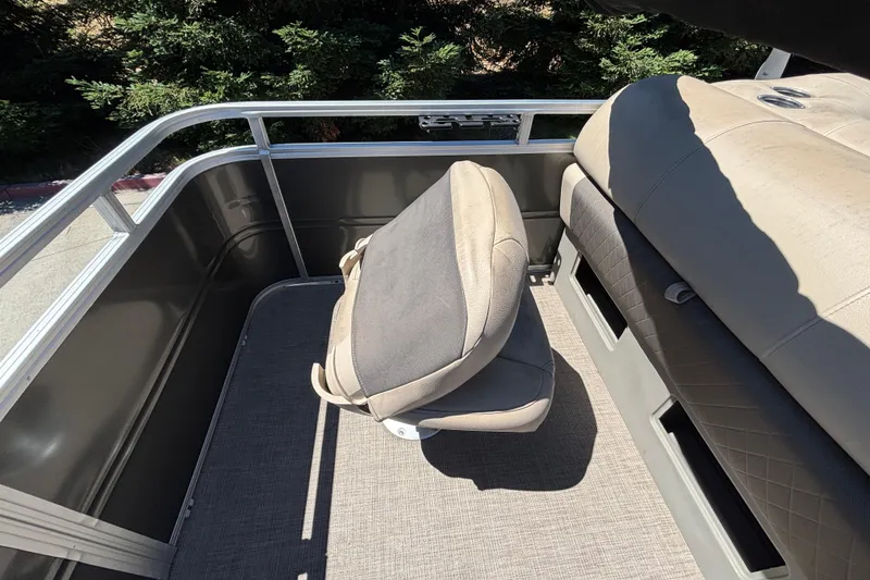 Slide: The Image of 2024 Sun Tracker Fishin' Barge 20 DLX interior with seating and railing. - 45