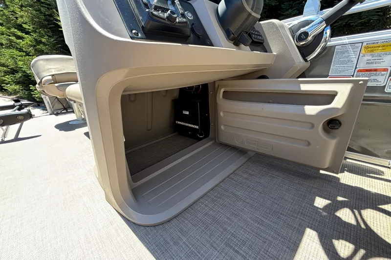 Slide: The Image of Open storage compartment on 2024 Sun Tracker Fishin' Barge 20 DLX boat. - 25