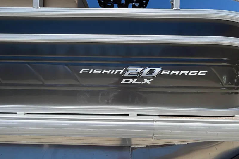 Slide: The Image of 2024 Sun Tracker Fishin' Barge 20 DLX logo on boat exterior. - 48
