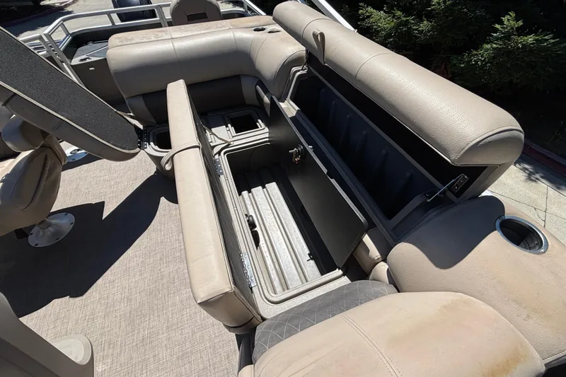 Slide: The Image of 2024 Sun Tracker Fishin' Barge 20 DLX interior with open storage compartments. - 41