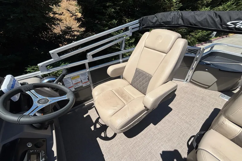Slide: The Image of 2024 Sun Tracker Fishin' Barge 20 DLX captain's chair and steering wheel. - 23