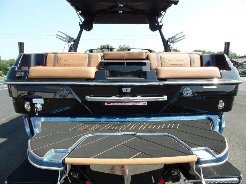 Slide: The Image of 2024 Malibu 23 LSV boat, rear view with luxurious seating and sleek design. - 3