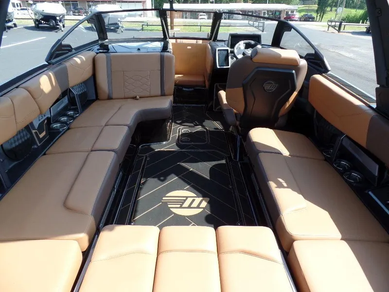 Slide: The Image of 2024 Malibu 23 LSV boat interior with luxurious tan seating and modern design. - 5