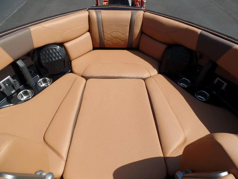 Slide: The Image of 2024 Malibu 23 LSV boat interior with tan leather seating and cup holders. - 6
