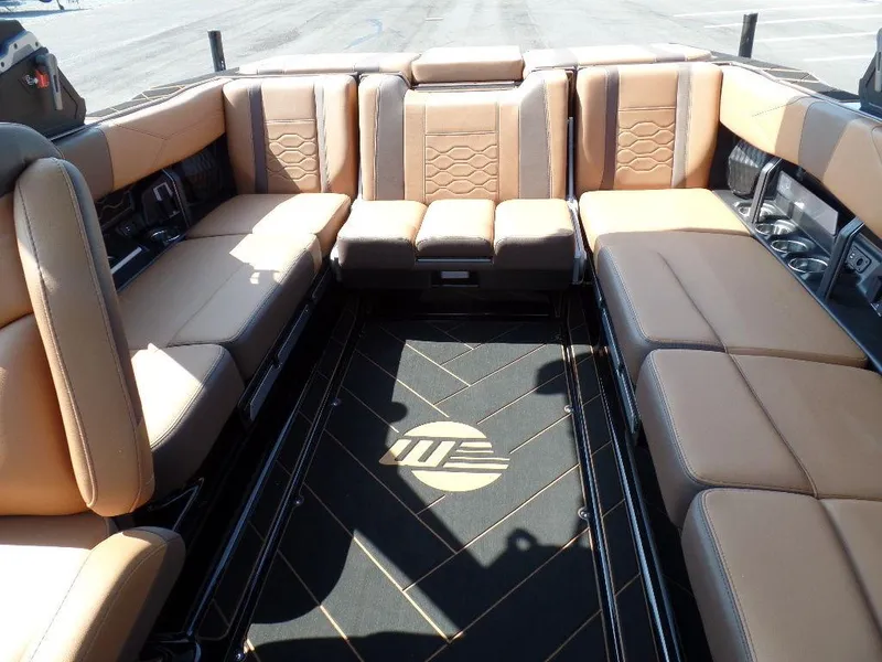 Slide: The Image of 2024 Malibu 23 LSV boat interior with luxurious tan seating and stylish flooring. - 8