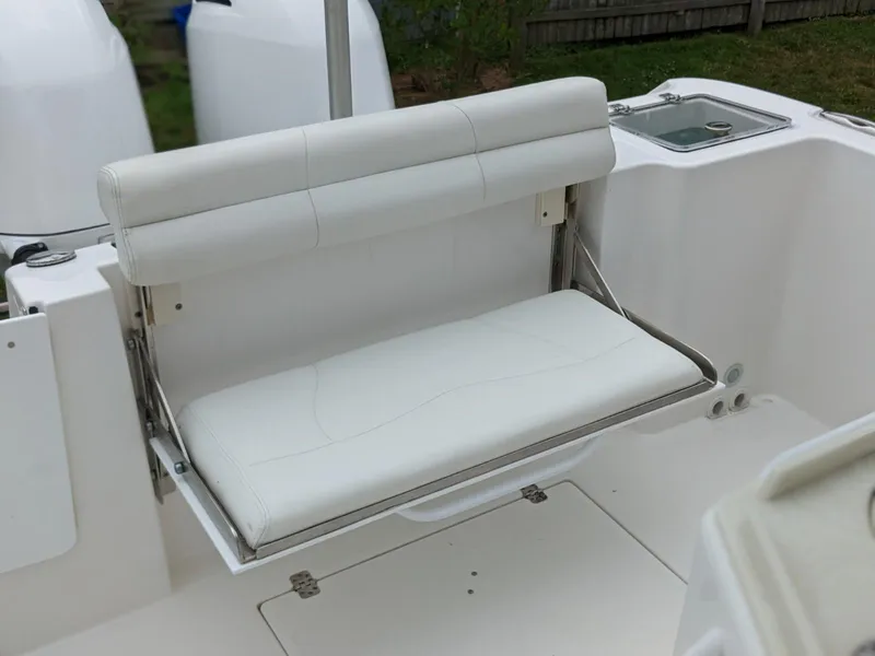 Slide: The Image of 2021 Edgewater 262 CC boat with white fold-down bench seat. - 12