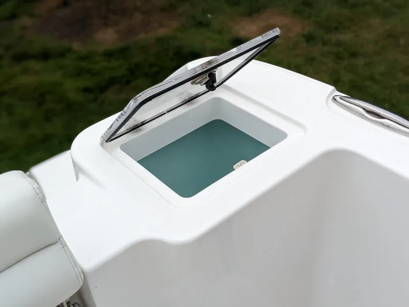 Slide: The Image of Open storage compartment on a 2021 Edgewater 262 CC boat. - 14