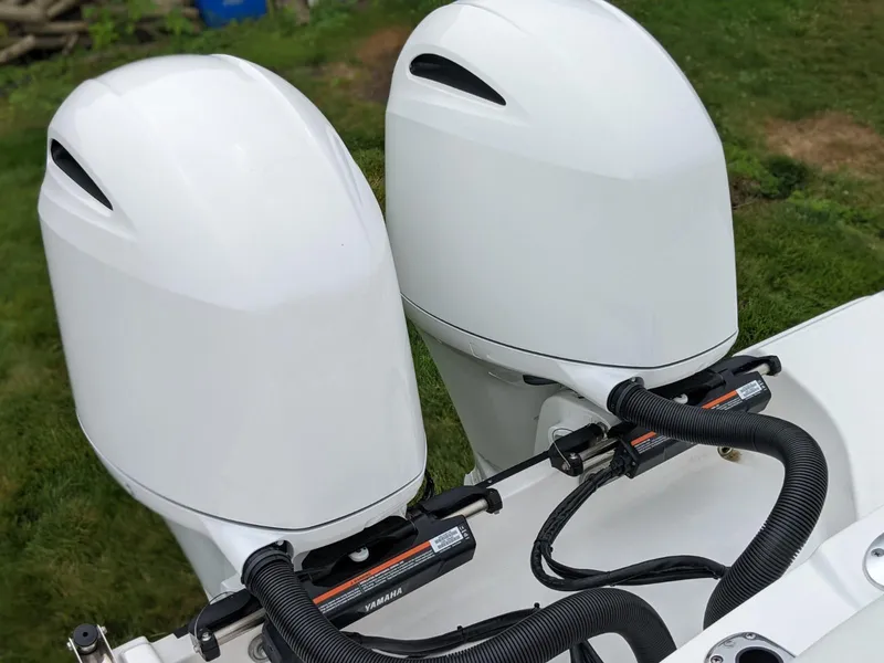Slide: The Image of Twin outboard engines on a 2021 Edgewater 262 CC boat. - 22
