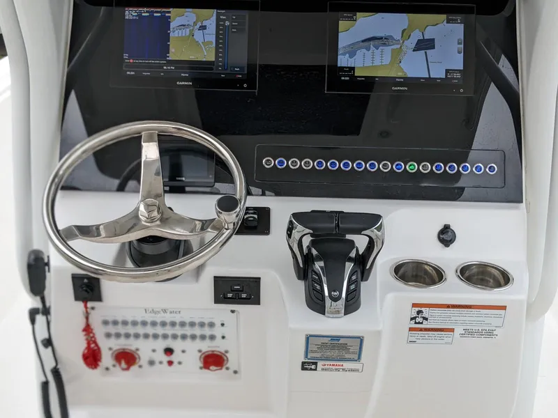 Slide: The Image of 2021 Edgewater 262 CC boat helm with dual displays and controls. - 7