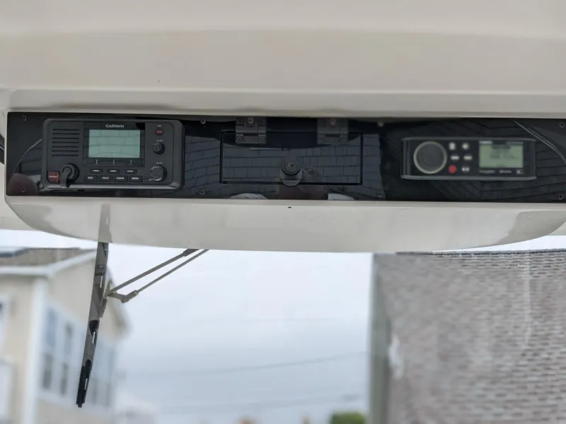 Slide: The Image of 2021 Edgewater 262 CC boat dashboard with Garmin electronics and radio. - 8