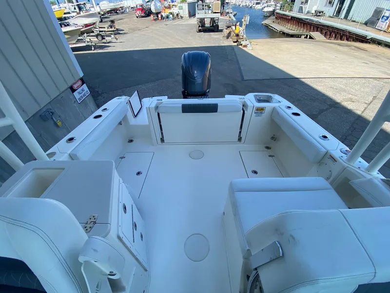 Slide: The Image of 2023 Cobia 240DC boat interior at a marina. - 3
