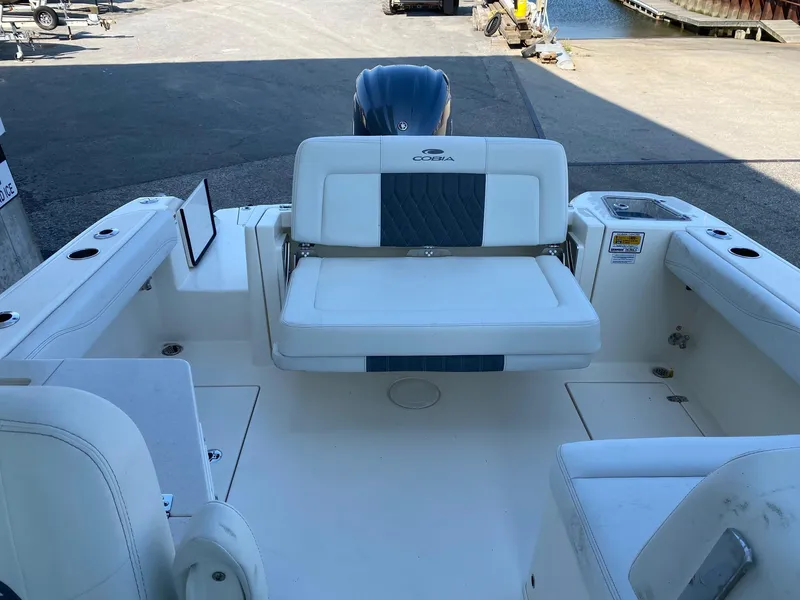Slide: The Image of 2023 Cobia 240DC boat interior with seating and outboard motor. - 4