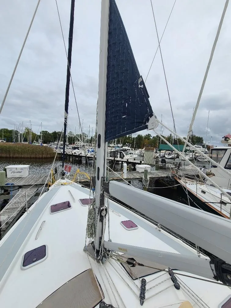 Slide: The Image of 2004 Hunter 466 sailboat docked at marina, overcast sky, view from deck. - 10
