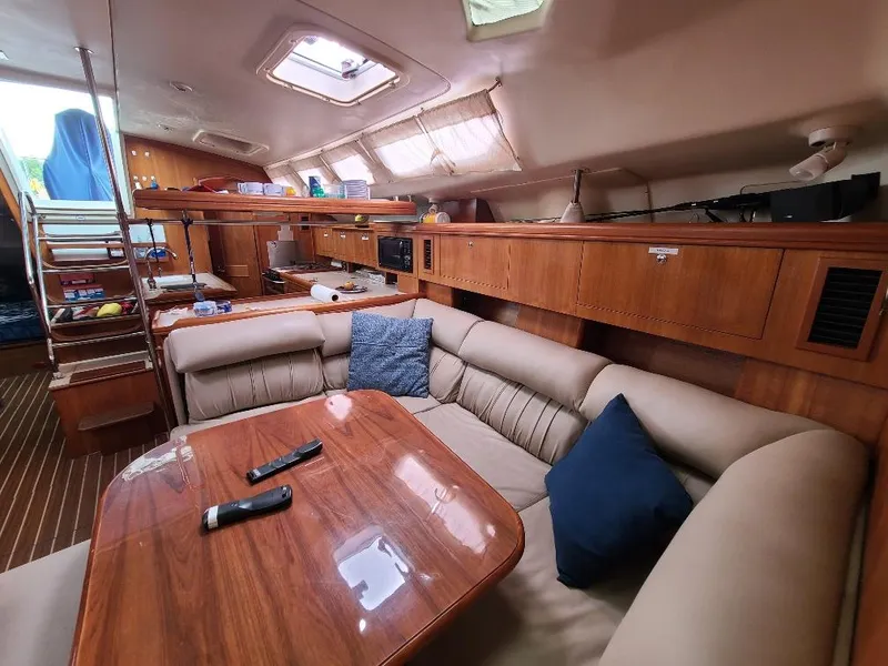 Slide: The Image of Luxurious interior of a 2004 Hunter 466 yacht with wooden furnishings and cozy seating. - 22