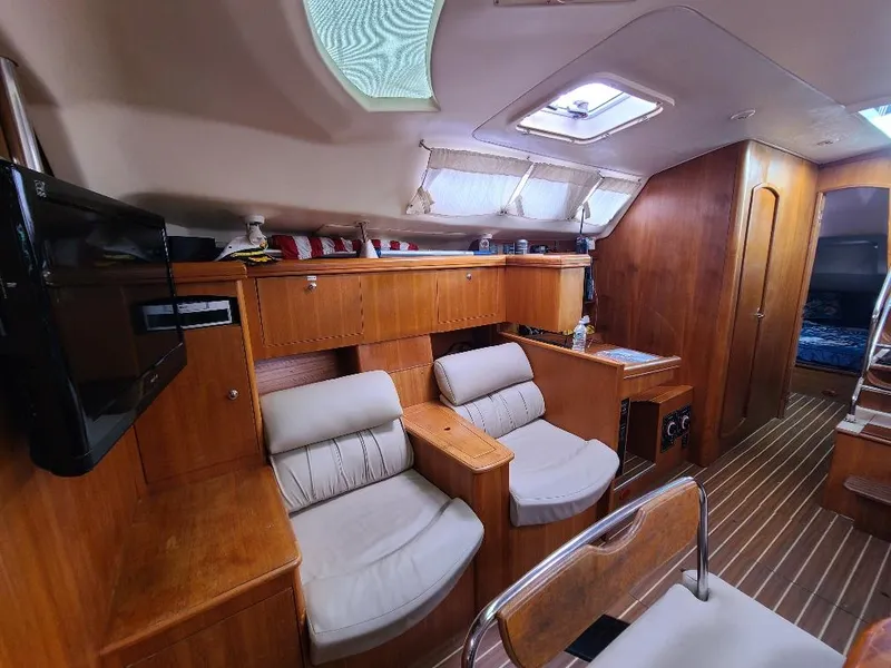 Slide: The Image of Interior of 2004 Hunter 466 yacht with wooden furnishings and seating area. - 23