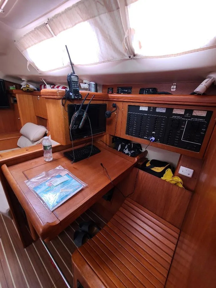 Slide: The Image of 2004 Hunter 466 yacht interior with navigation station and communication equipment. - 25