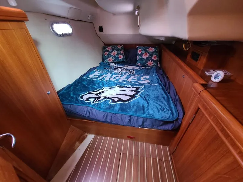 Slide: The Image of Cozy cabin interior of 2004 Hunter 466 yacht with Eagles-themed bedding. - 30