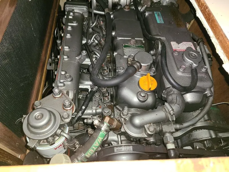 Slide: The Image of 2004 Hunter 466 engine compartment with visible components and hoses. - 31