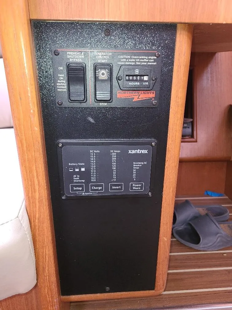 Slide: The Image of Control panel of a 2004 Hunter 466 boat with generator and Xantrex system. - 32