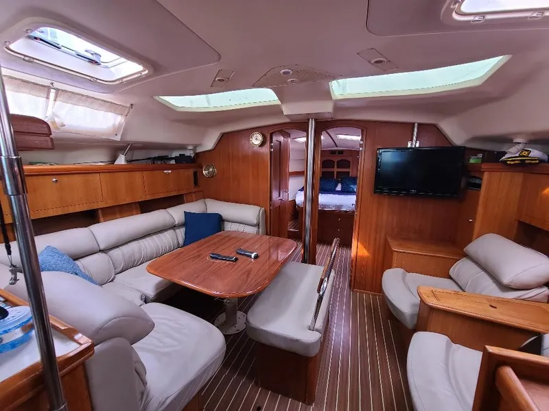 Slide: The Image of Luxurious interior of a 2004 Hunter 466 yacht with comfortable seating and wooden finishes. - 33