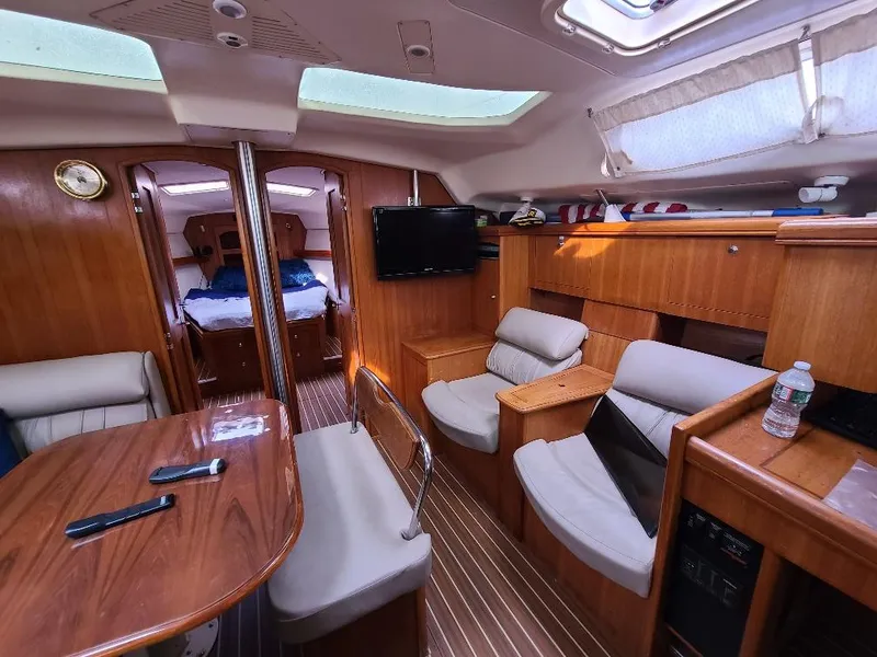 Slide: The Image of Luxurious interior of a 2004 Hunter 466 yacht with wood finish and comfortable seating. - 34
