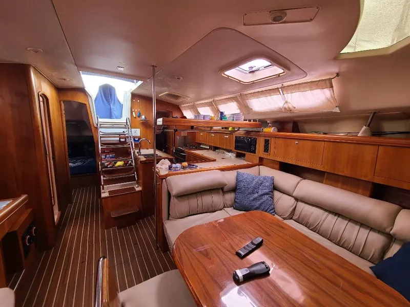Slide: The Image of Luxurious interior of 2004 Hunter 466 yacht with wood finish and comfortable seating. - 35