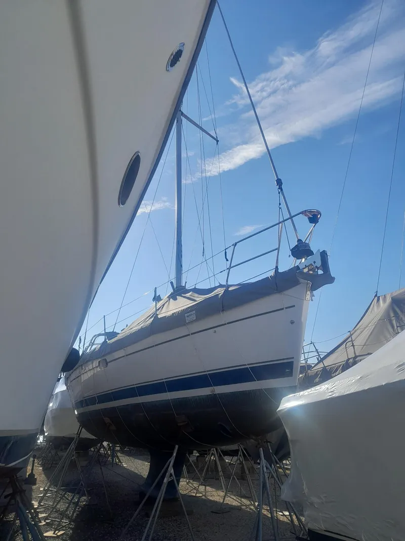 Slide: The Image of Sailboat Hunter 466, 2004 model, docked on land under clear blue sky. - 42