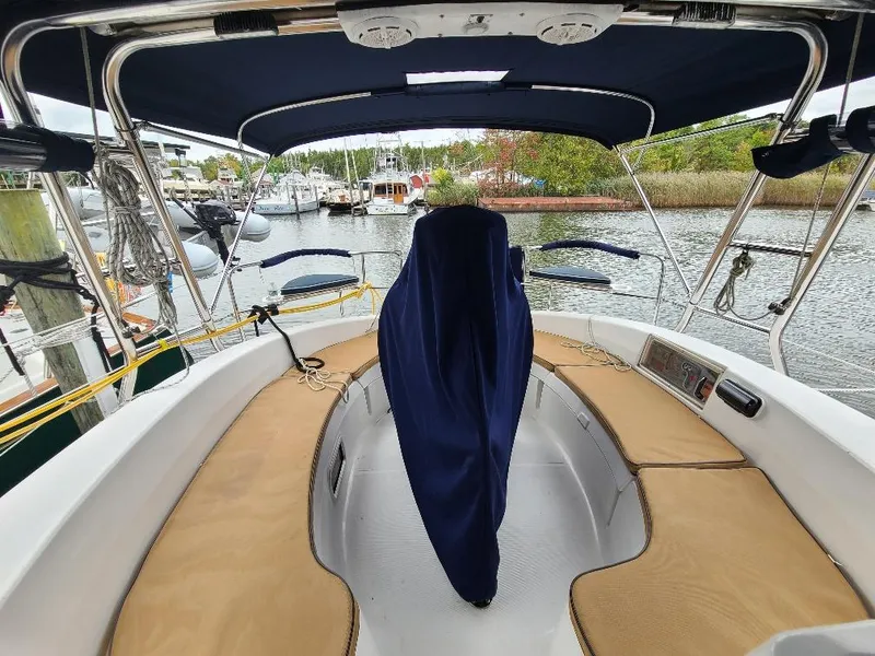 Slide: The Image of Interior view of a 2004 Hunter 466 sailboat cockpit with covered helm. - 7