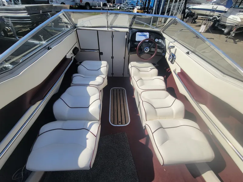 Slide: The Image of Interior of a 1991 Maxum 2100 XC boat with white and maroon seating. - 12