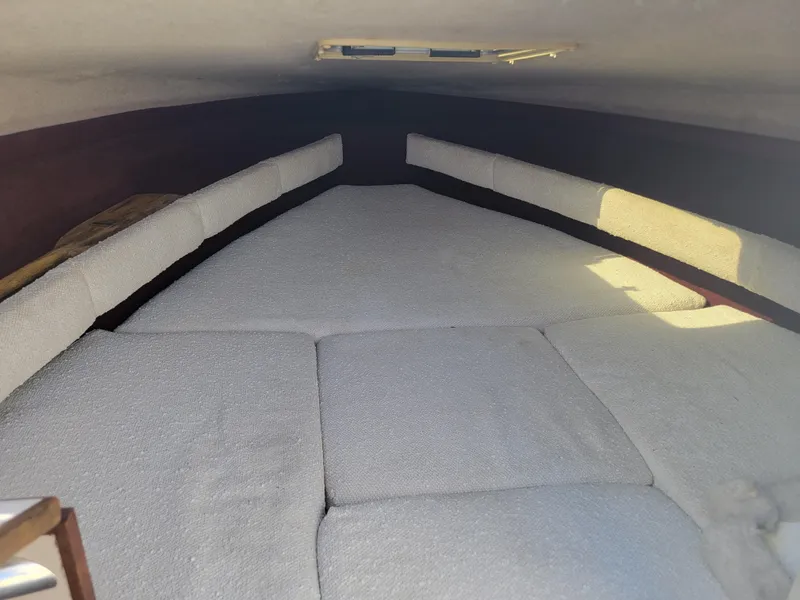 Slide: The Image of Interior cabin of a 1991 Maxum 2100 XC boat with cushioned seating. - 16
