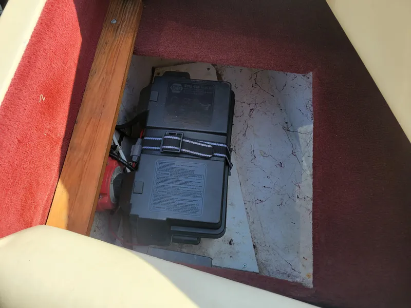 Slide: The Image of Battery compartment of a 1991 Maxum 2100 XC boat with red carpet. - 22
