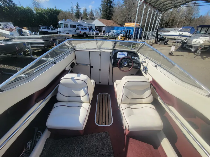 Slide: The Image of 1991 Maxum 2100 XC boat interior with white seats and steering wheel. - 5