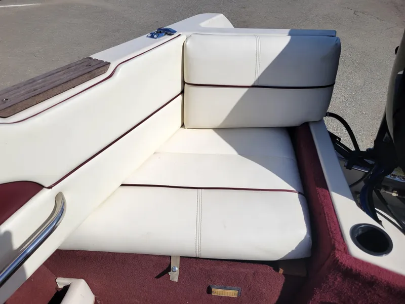 Slide: The Image of 1991 Maxum 2100 XC boat interior with white and maroon seating. - 9