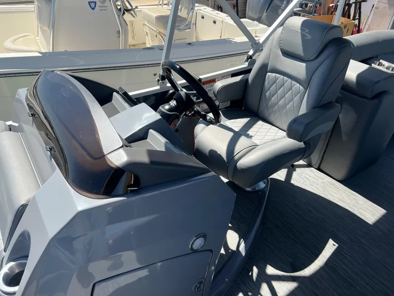 Slide: The Image of 2022 Bennington 23 L boat interior with captain's chair and steering console. - 11