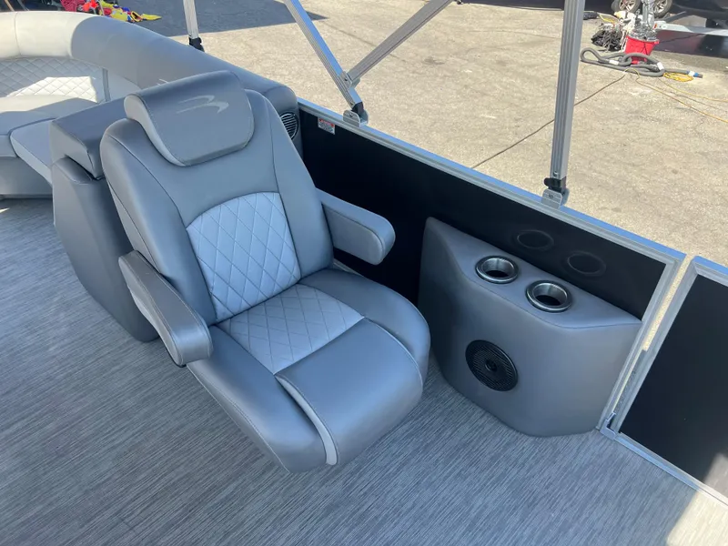 Slide: The Image of 2022 Bennington 23 L boat with luxurious gray captain's chair and cup holders. - 12