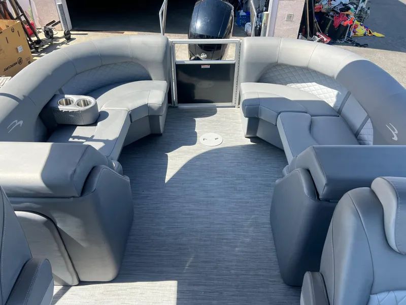 Slide: The Image of 2022 Bennington 23 L pontoon boat interior with gray seating and cup holders. - 13