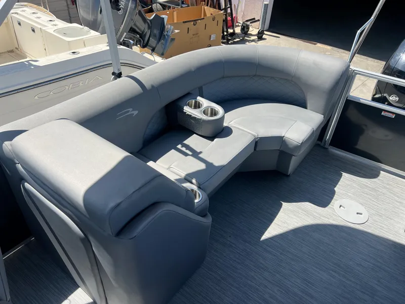Slide: The Image of 2022 Bennington 23 L boat interior with gray seating and cup holders. - 15