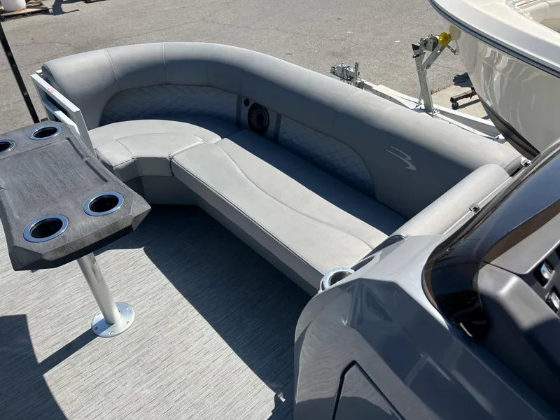 Slide: The Image of 2022 Bennington 23 L boat with gray seating and cupholder table. - 17